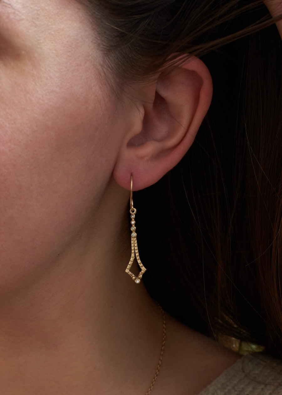 14k solid gold diamond dangle Shaon earrings on model