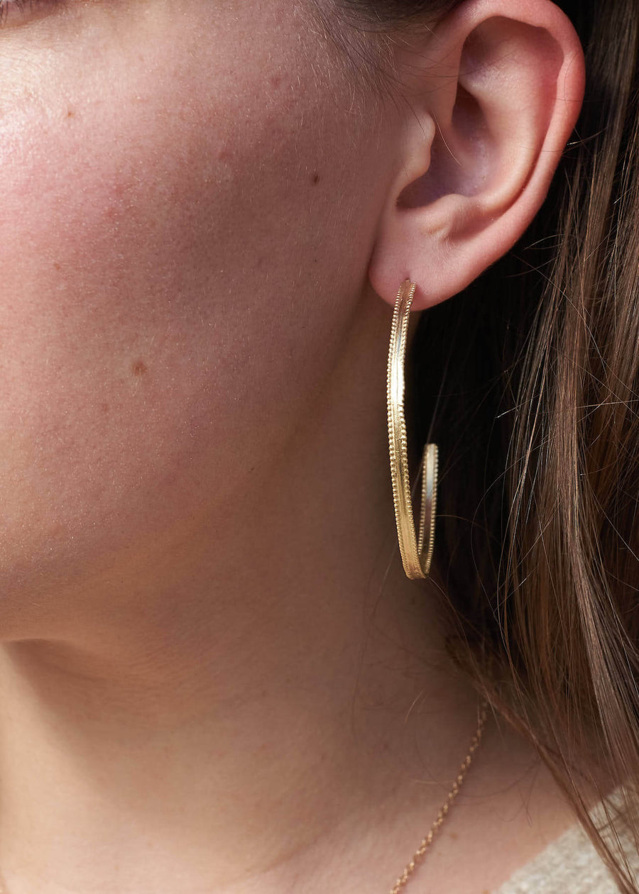 14k solid 14k gold hoop earrings with beaded texture on model, eternal hoops, ready to ship